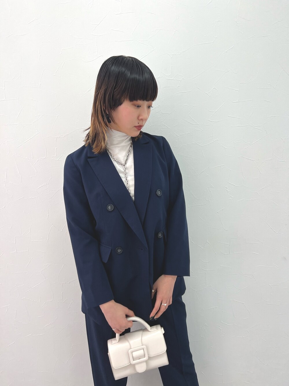 ブルー系のテーラードジャケット、ブルー系のパンツ、ホワイト系のTシャツ/カットソーを着用したレディースの冬コーディネートの4枚目の写真