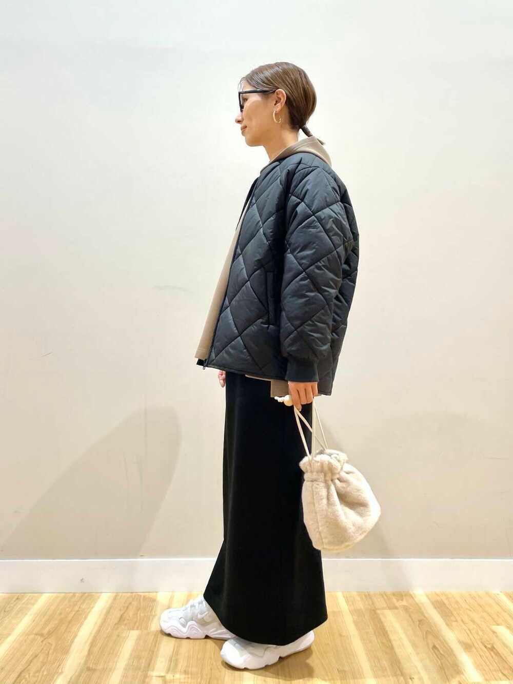 ホワイト系のスニーカー、ホワイト系のショルダーバッグ、ブラウン系のワンピースを着用したレディースの冬コーディネートの5枚目の写真