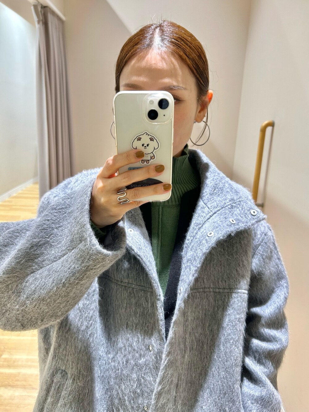 グレー系のその他アウター、グリーン系のニット/セーター、ブラック系のジャンパースカートを着用したレディースの冬コーディネートの8枚目の写真