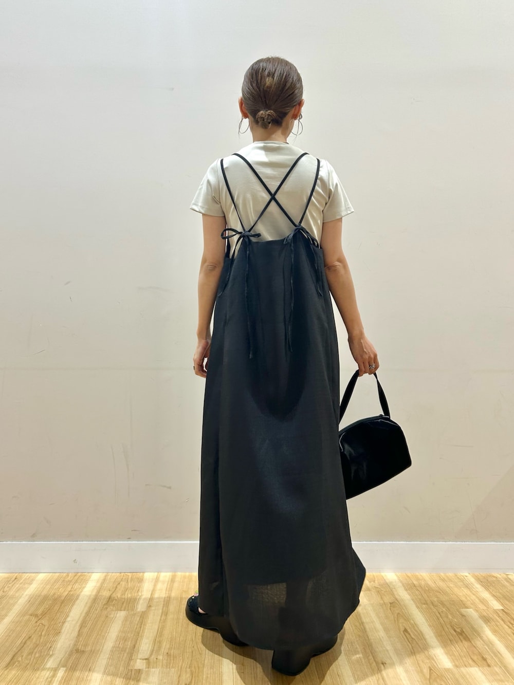 グレー系のワンピース、ベージュ系のTシャツ/カットソー、ブラック系のトートバッグを着用したレディースの夏コーディネートの2枚目の写真