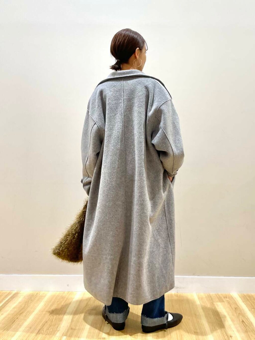 ブラック系のパンプス、ブルー系のデニムパンツ、グレー系のその他アウターを着用したレディースの冬コーディネートの7枚目の写真