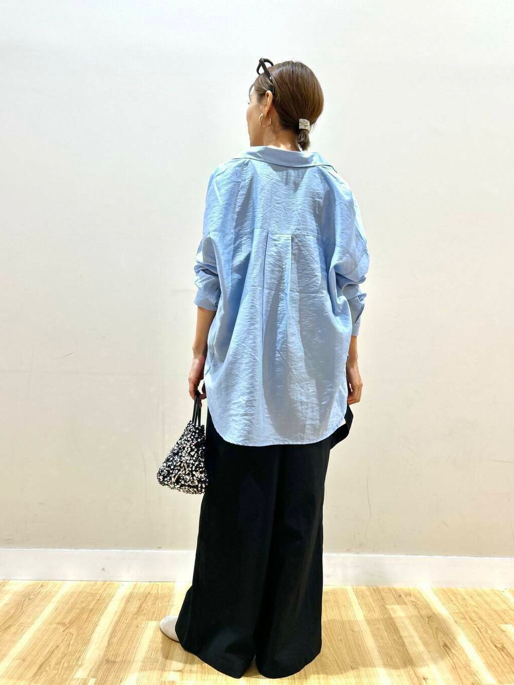 ブルー系のシャツ/ブラウス、シルバー系のショルダーバッグ、ブラック系のサロペット/オーバーオールを着用したレディースの春コーディネートの5枚目の写真