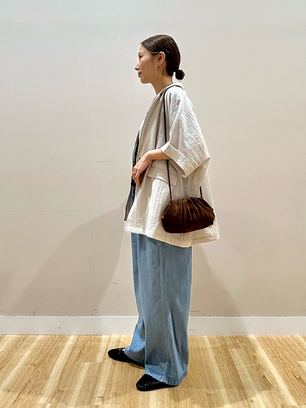 グレー系のTシャツ/カットソー、ブルー系のデニムパンツ、グレー系のその他アウターを着用したレディースの春コーディネートの4枚目の写真