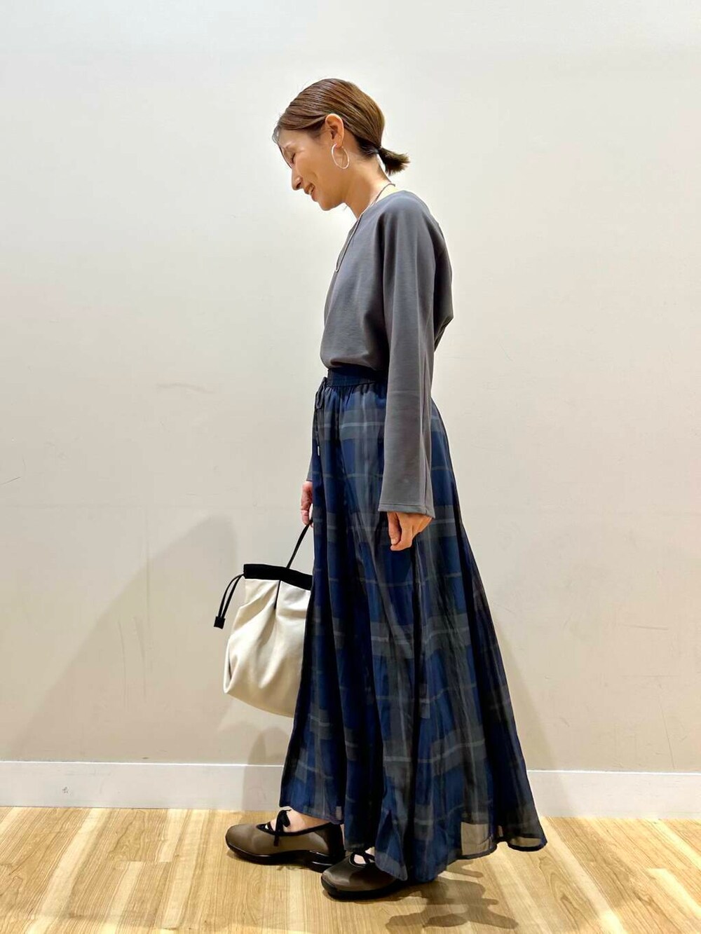 ホワイト系のショルダーバッグ、グレー系のTシャツ/カットソー、グリーン系のスニーカーを着用したレディースの春コーディネートの4枚目の写真