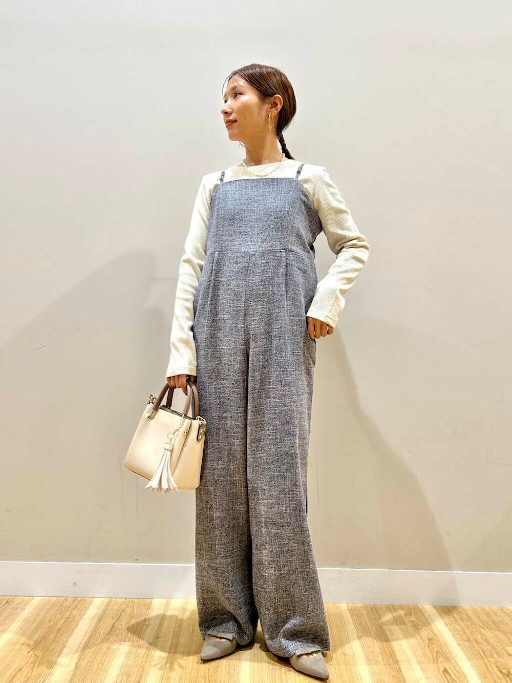 ホワイト系のトートバッグ、グレー系のパンプス、ブラック系のノーカラージャケットを着用したレディースの冬コーディネートの5枚目の写真