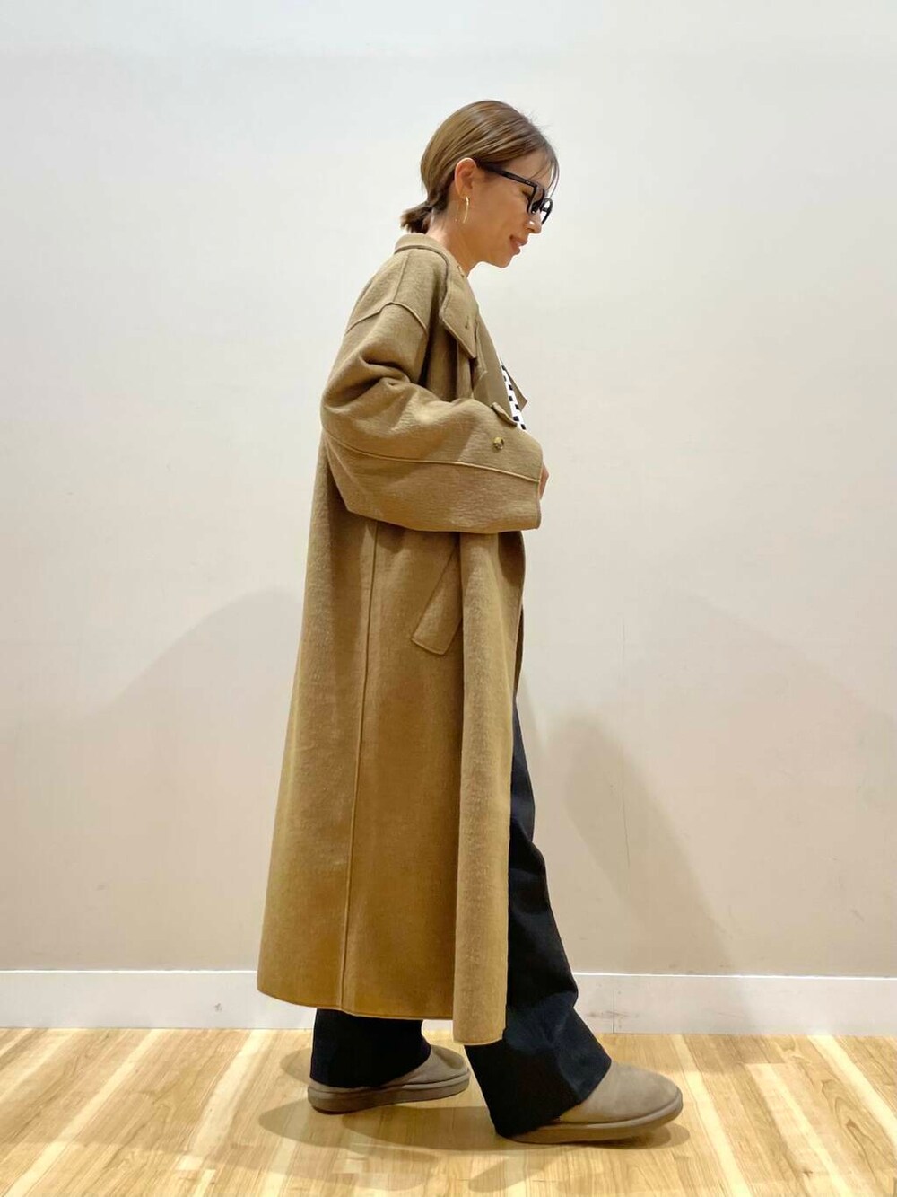 ブラック系のハンドバッグ、ブラック系のニット/セーター、ブラック系のデニムパンツを着用したレディースの秋コーディネートの6枚目の写真