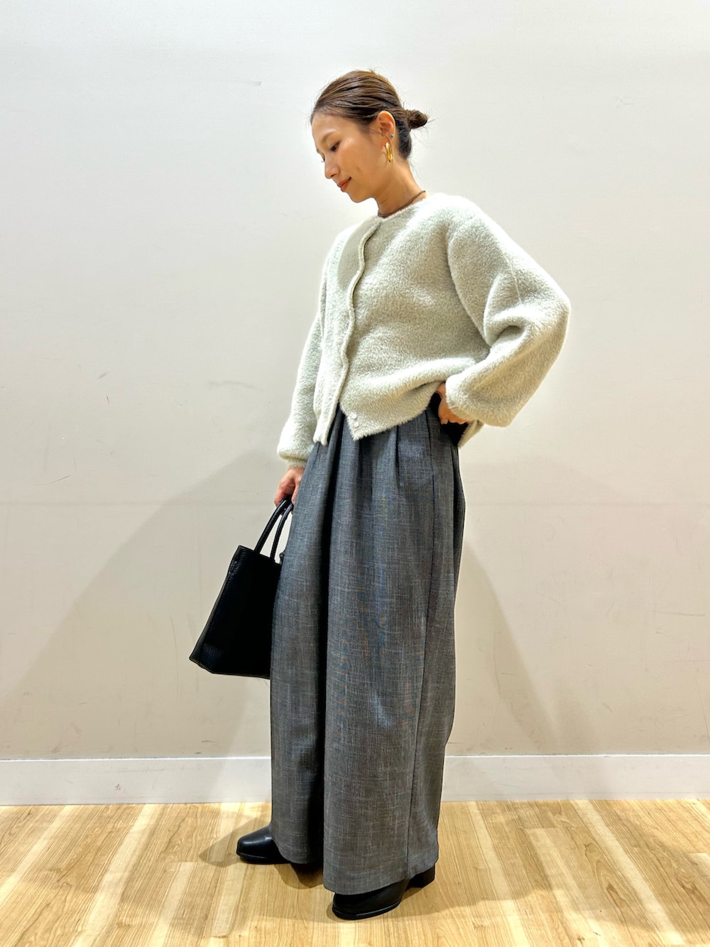 ベージュ系のニット/セーター、ブラック系のその他パンツ、ブラック系のトートバッグを着用したレディースの秋コーディネートの2枚目の写真