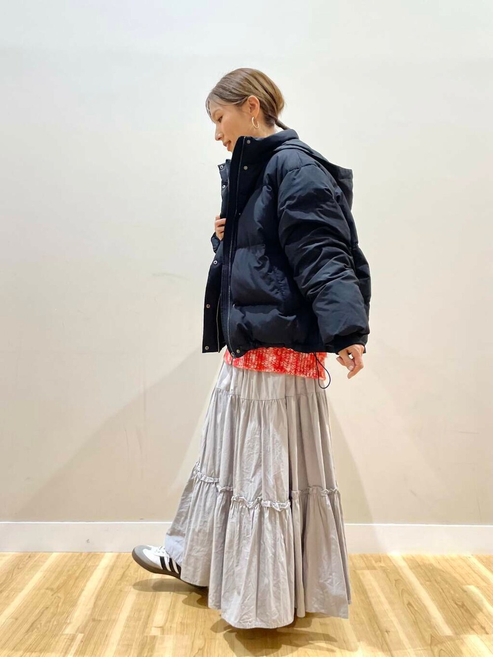 ブラック系のダウンジャケット/コート、グリーン系のショルダーバッグ、レッド系のニット/セーターを着用したレディースの冬コーディネートの4枚目の写真