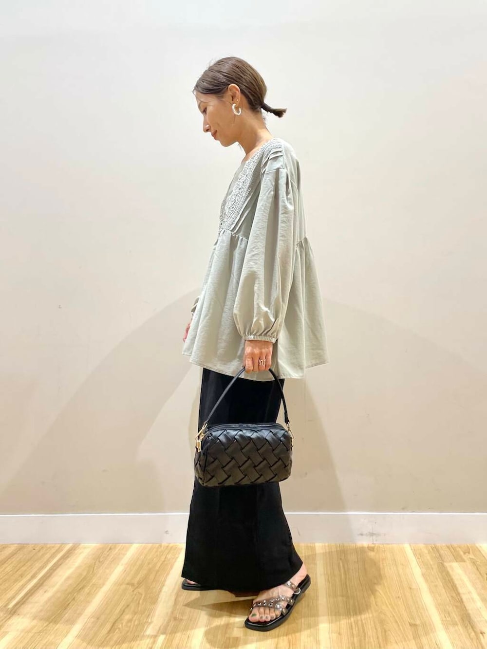 グリーン系のシャツ/ブラウス、ブラック系のサンダル、ブラック系のスカートを着用したレディースの夏コーディネートの5枚目の写真