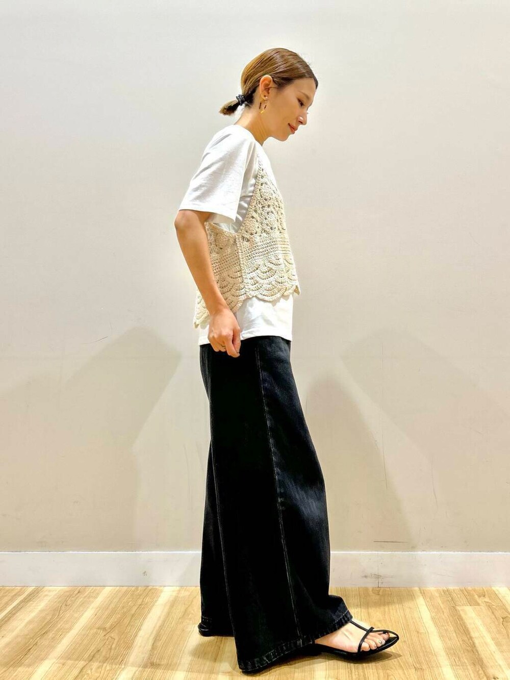 ブラック系のデニムパンツ、ベージュ系のTシャツ/カットソーを着用したレディースの夏コーディネートの2枚目の写真