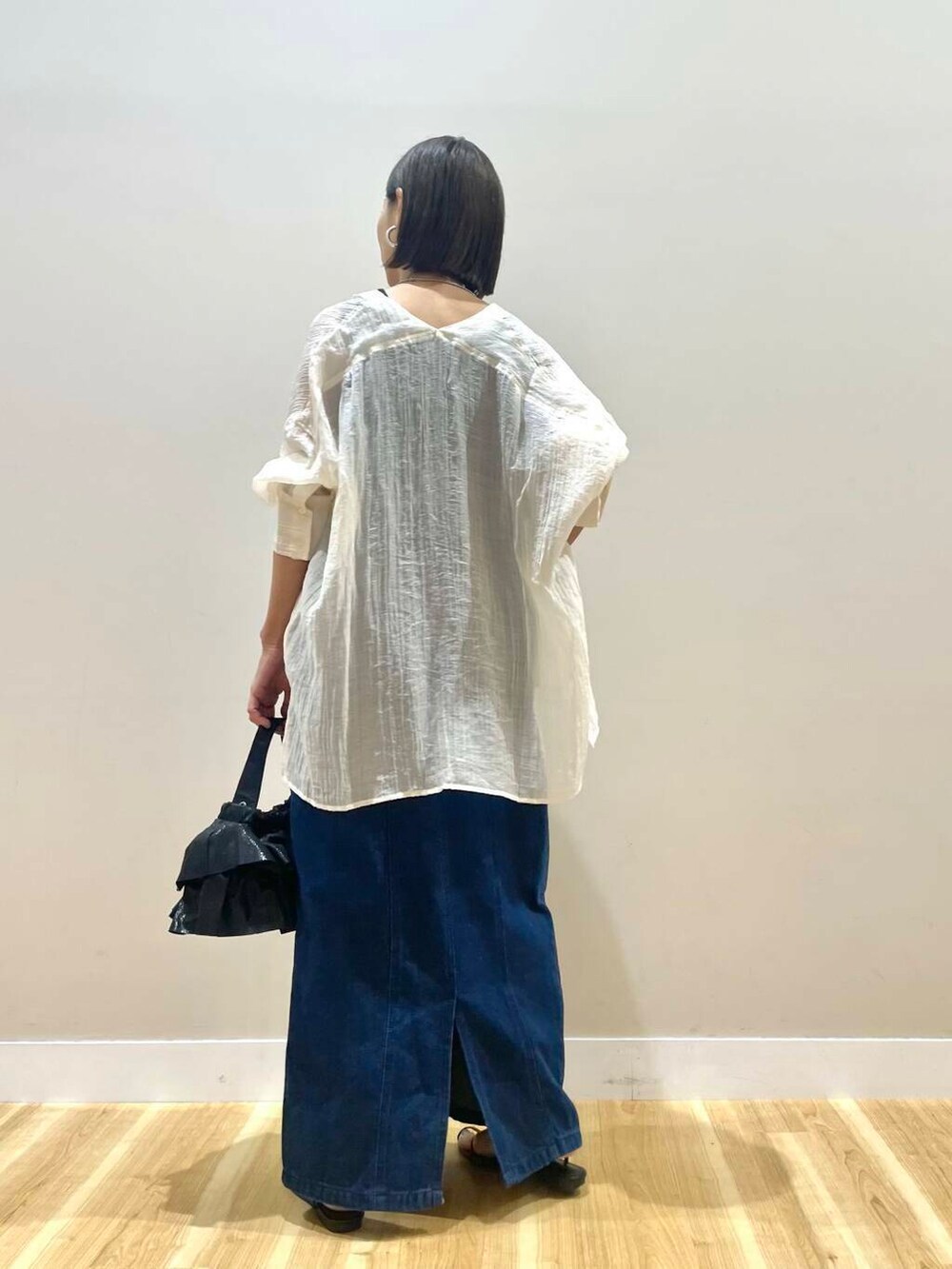 ブラック系のショルダーバッグ、ブルー系のワンピース、ホワイト系のシャツ/ブラウスを着用したレディースの秋コーディネートの3枚目の写真