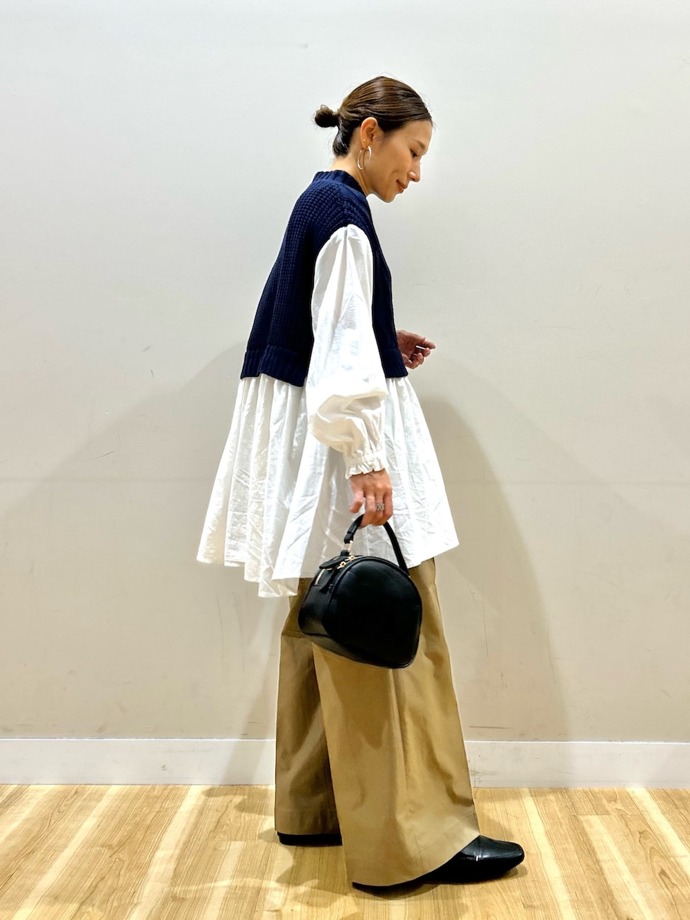 ホワイト系のシャツ/ブラウス、ベージュ系のチノパンツ、ブラック系のショルダーバッグを着用したレディースの秋コーディネートの4枚目の写真