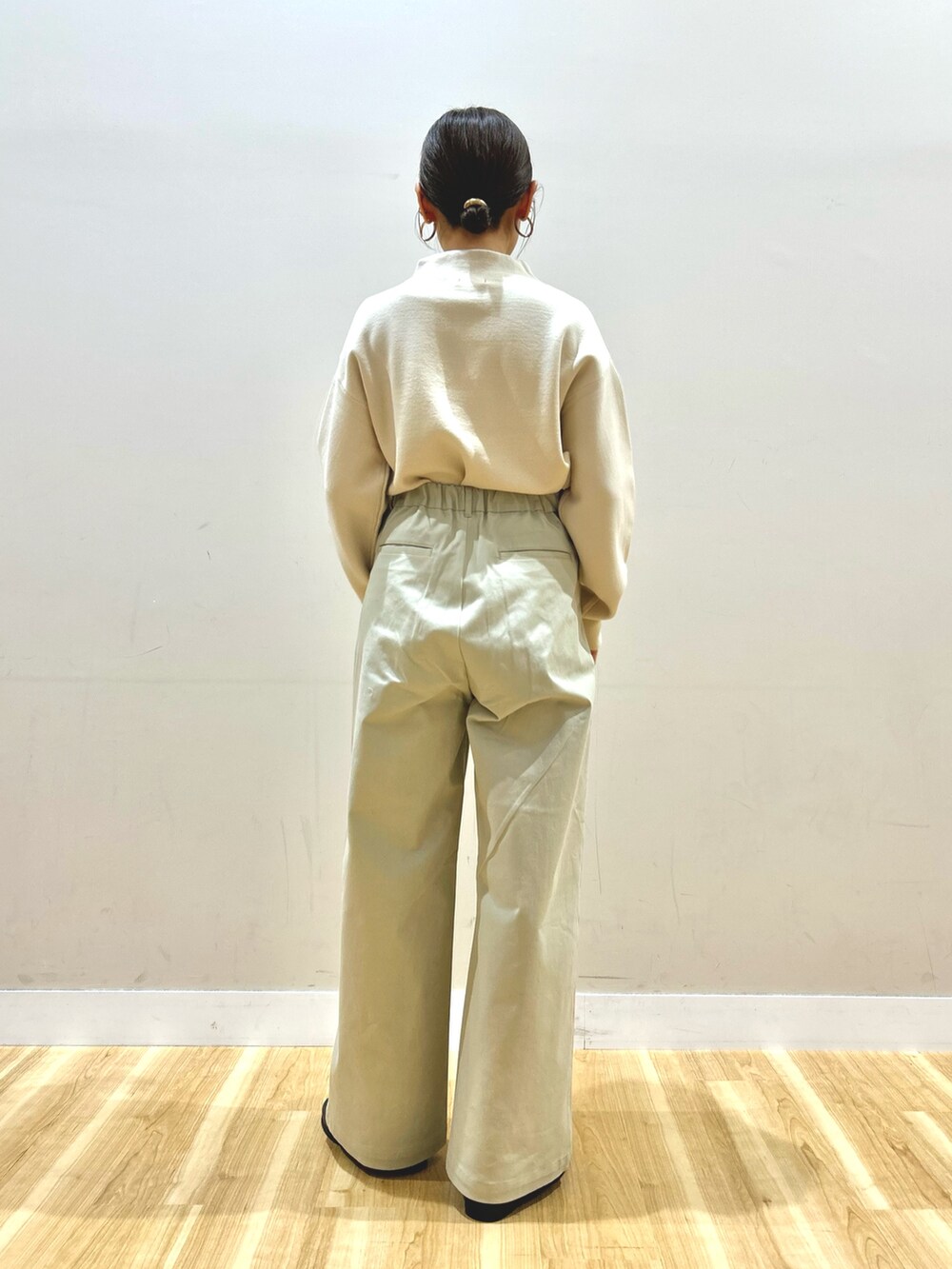 ブルー系のダウンジャケット/コート、ホワイト系のニット/セーター、ベージュ系のその他パンツを着用したレディースの冬コーディネートの6枚目の写真