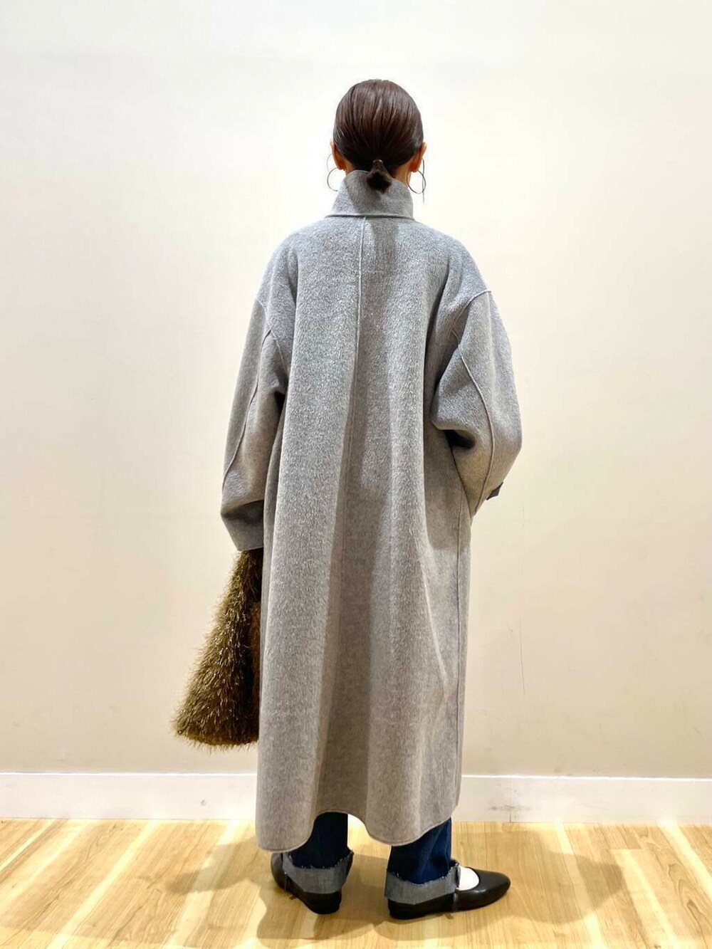 ブラック系のパンプス、ブルー系のデニムパンツ、グレー系のその他アウターを着用したレディースの冬コーディネートの5枚目の写真