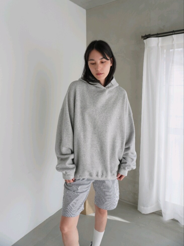 グレー系のパーカー、グレー系のエコバッグ/サブバッグを着用したレディースの春コーディネートの2枚目の写真