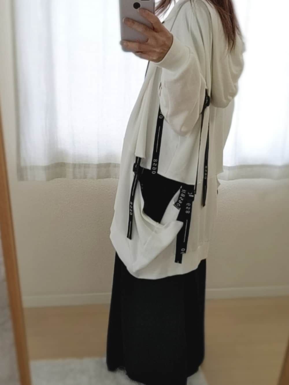 ホワイト系のパーカー、ブラック系のスラックスを着用したメンズの夏コーディネートの2枚目の写真