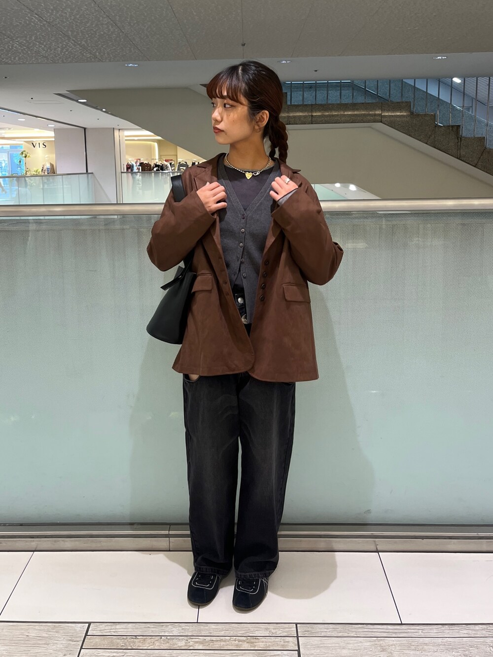 ブラック系のデニムパンツ、グレー系のTシャツ/カットソー、ブラウン系のテーラードジャケットを着用したレディースの秋コーディネートの3枚目の写真