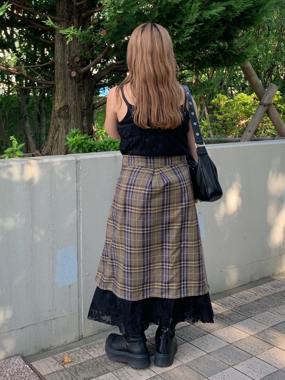 ブラック系のワンピース、ブラック系のショルダーバッグを着用したレディースの秋コーディネートの3枚目の写真