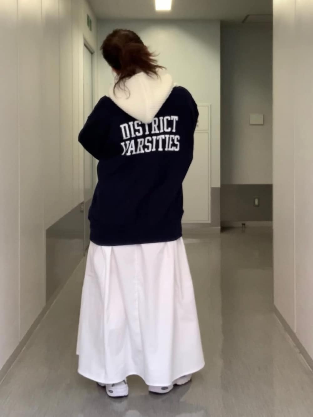 グレー系のワンピース、ブルー系のスウェット、ホワイト系のニットキャップ/ビーニーを着用したレディースの秋コーディネートの3枚目の写真