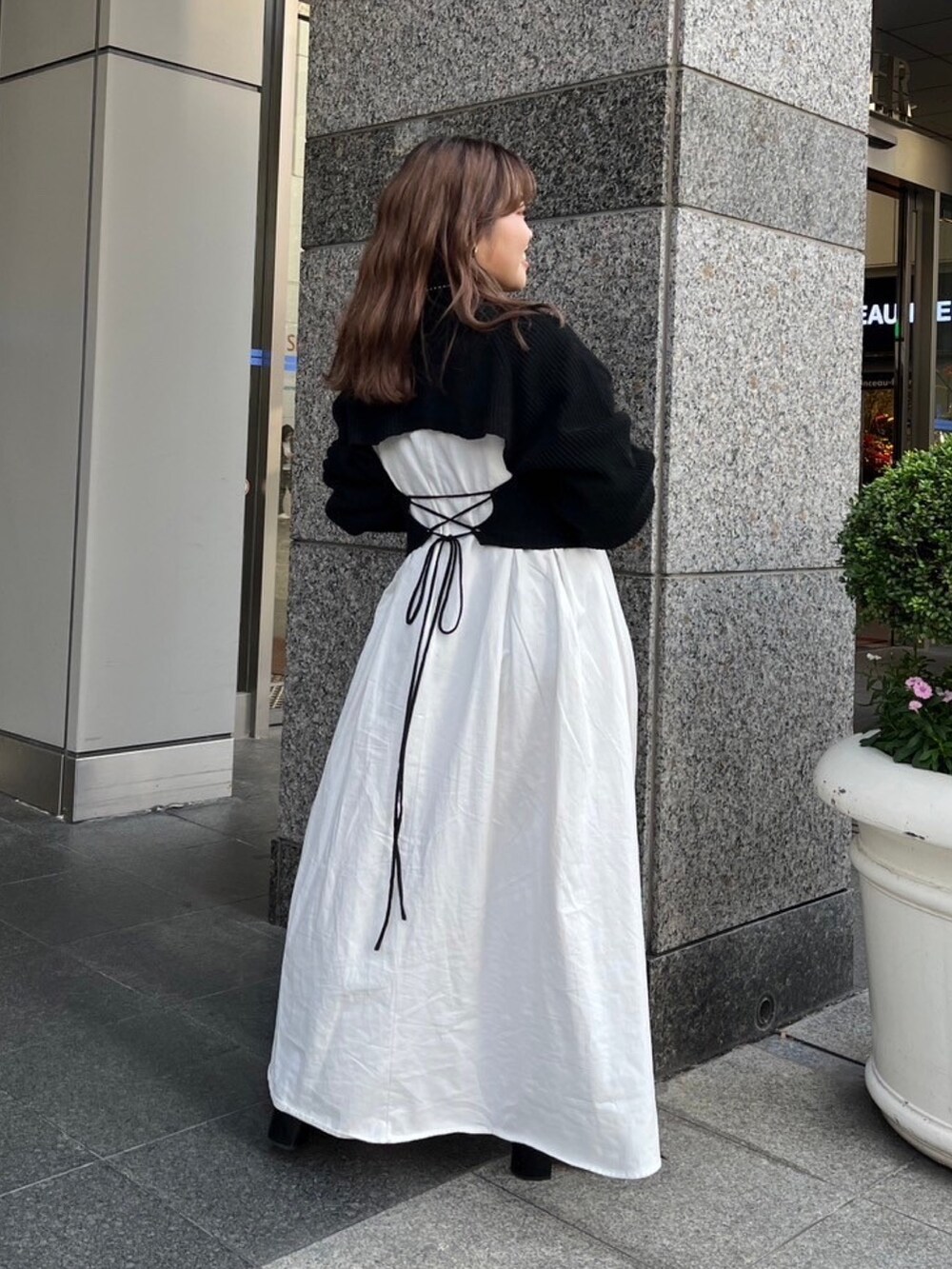 ブラウン系のムートンコート、ブラック系のワンピースを着用したレディースの秋コーディネートの7枚目の写真