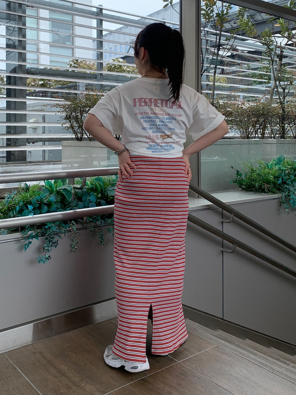 レッド系のワンピース、ホワイト系のTシャツ/カットソーを着用したレディースの春コーディネートの3枚目の写真