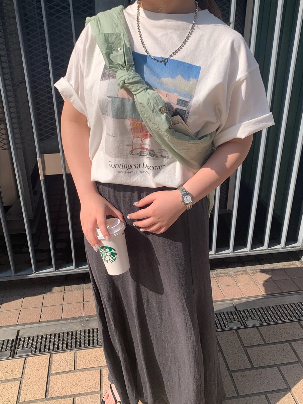 ホワイト系のTシャツ/カットソー、グリーン系のシャツ/ブラウス、グレー系のスカートを着用したレディースの春コーディネートの3枚目の写真