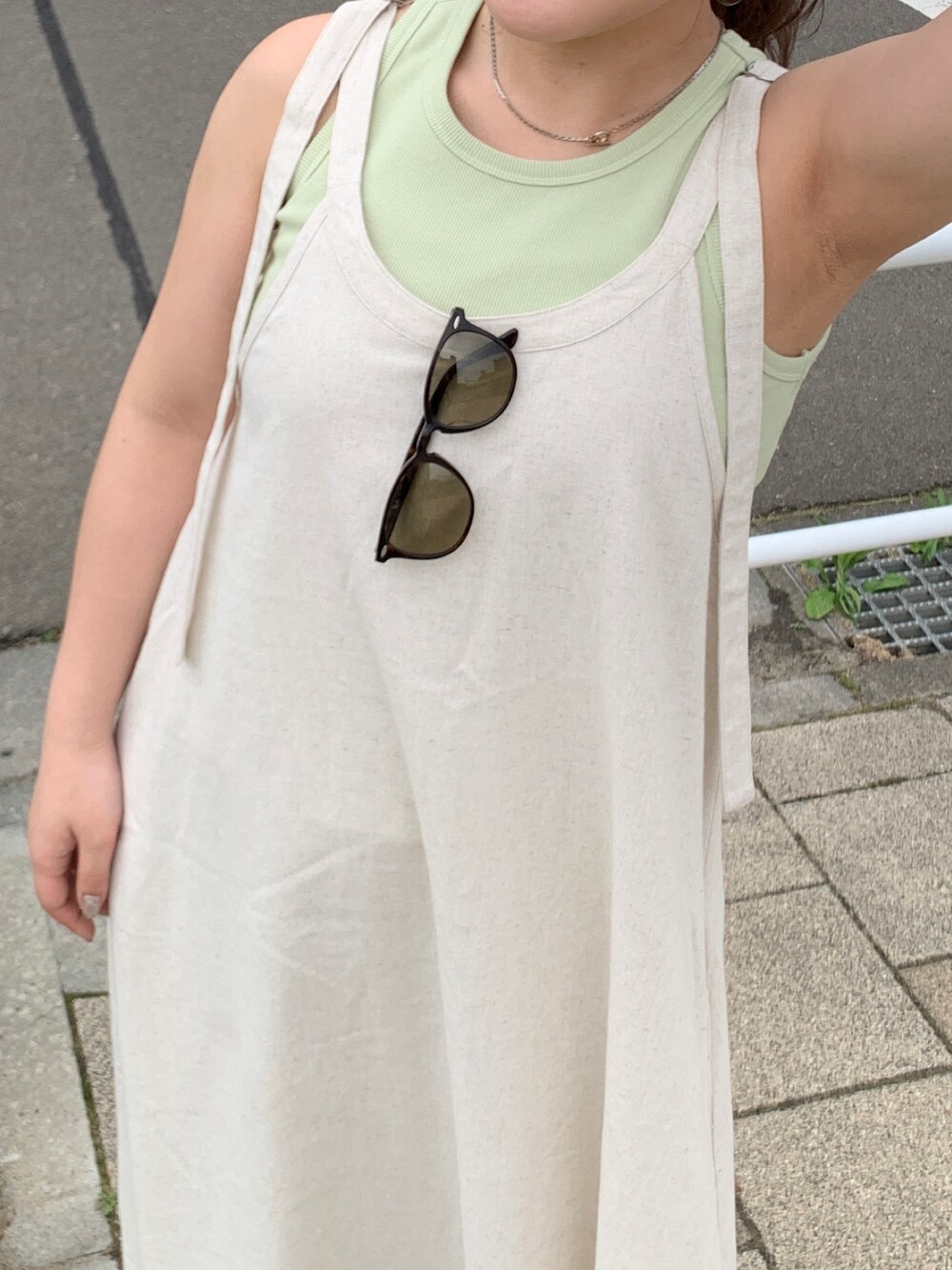 ホワイト系のワンピース、グリーン系のタンクトップを着用したレディースの春コーディネートの4枚目の写真