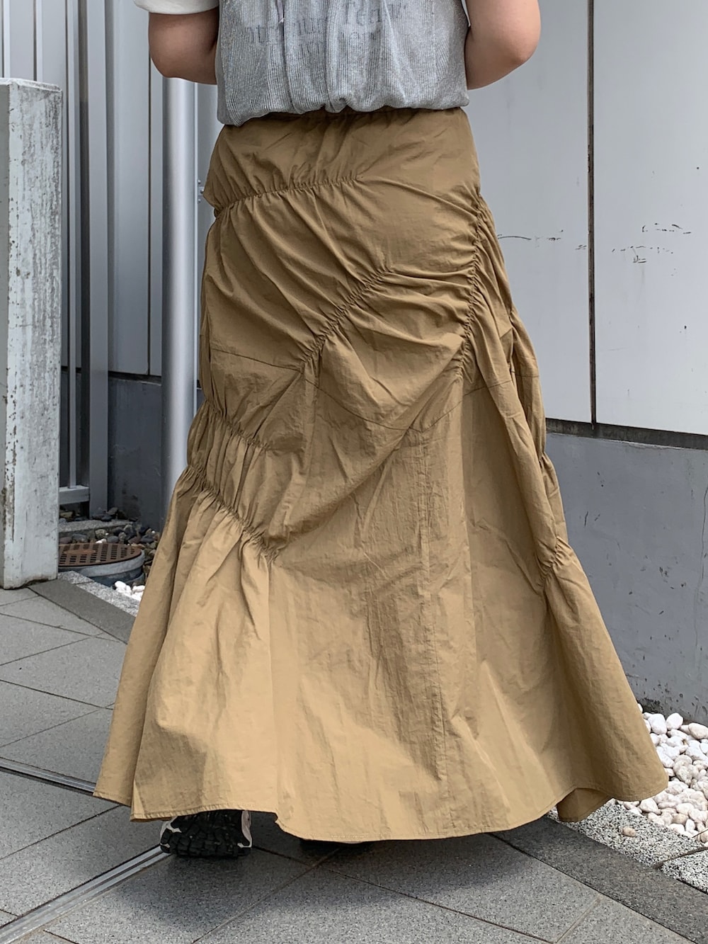 ホワイト系のTシャツ/カットソー、シルバー系のキャミソール、ベージュ系のスカートを着用したレディースの春コーディネートの7枚目の写真