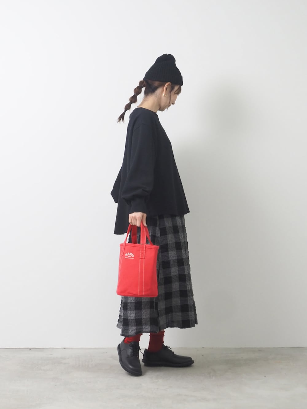 ブラック系のTシャツ/カットソー、ブラック系のスカートを着用したレディースの秋コーディネートの2枚目の写真