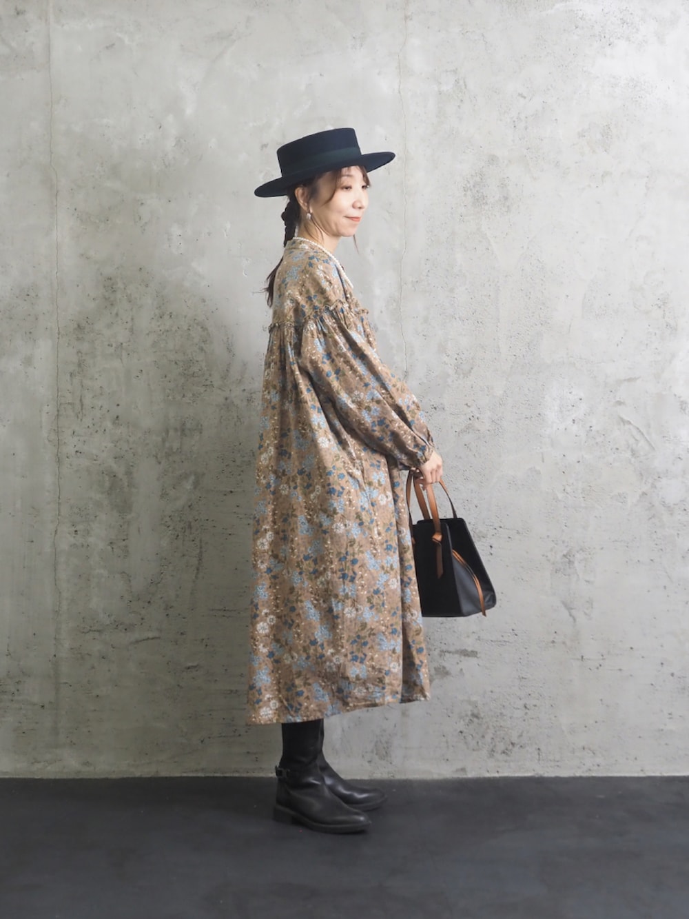 ベージュ系のワンピースを着用したレディースの秋コーディネートの2枚目の写真