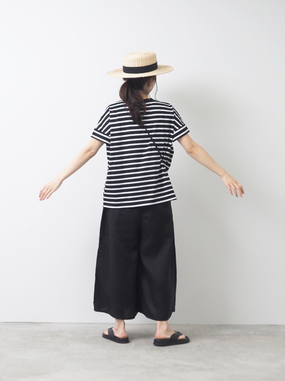 ブラック系のTシャツ/カットソー、ブラック系のパンツを着用したレディースの夏コーディネートの2枚目の写真