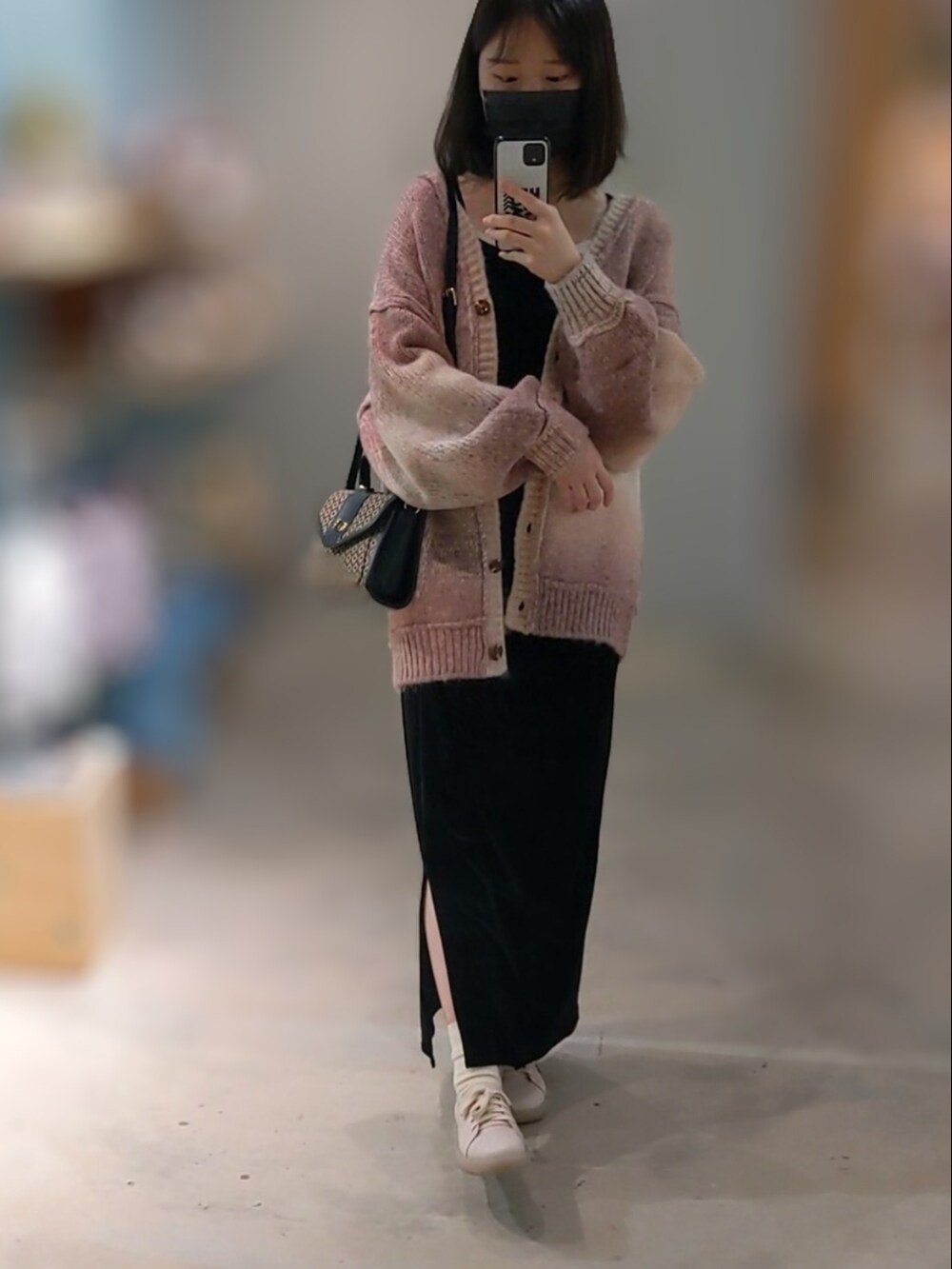 ピンク系のカーディガン/ボレロ、ブラック系のワンピース、ブラウン系のショルダーバッグを着用したレディースの秋コーディネートの2枚目の写真
