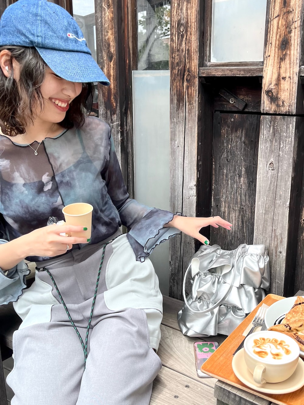 グレー系のその他パンツ、シルバー系のトートバッグ、ブルー系のTシャツ/カットソーを着用したレディースの夏コーディネートの2枚目の写真