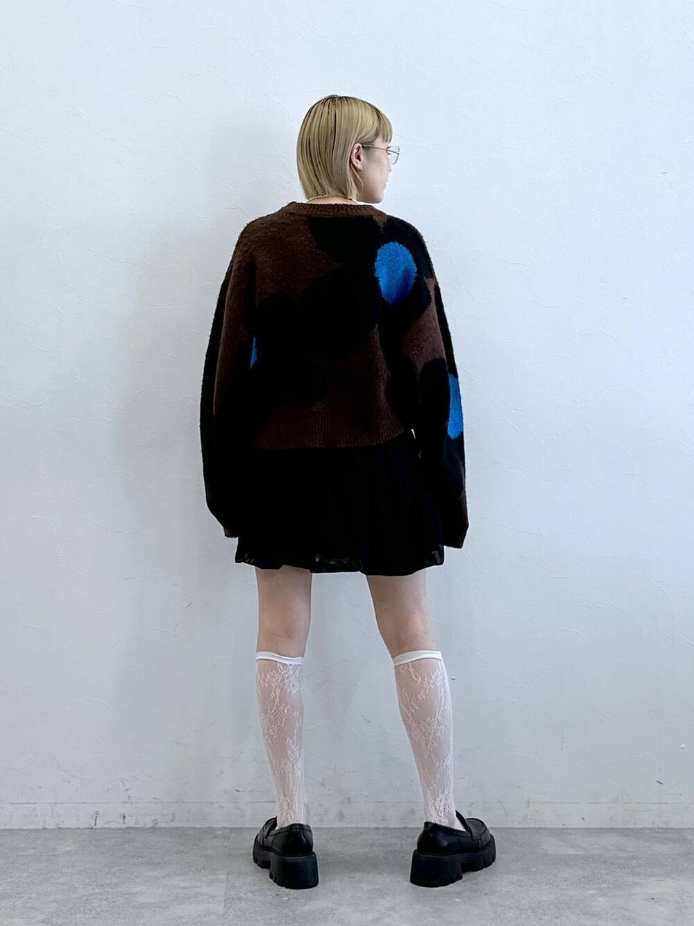 ブラック系のローファー、ブラック系のスカート、ブラウン系のニット/セーターを着用したレディースの夏コーディネートの6枚目の写真