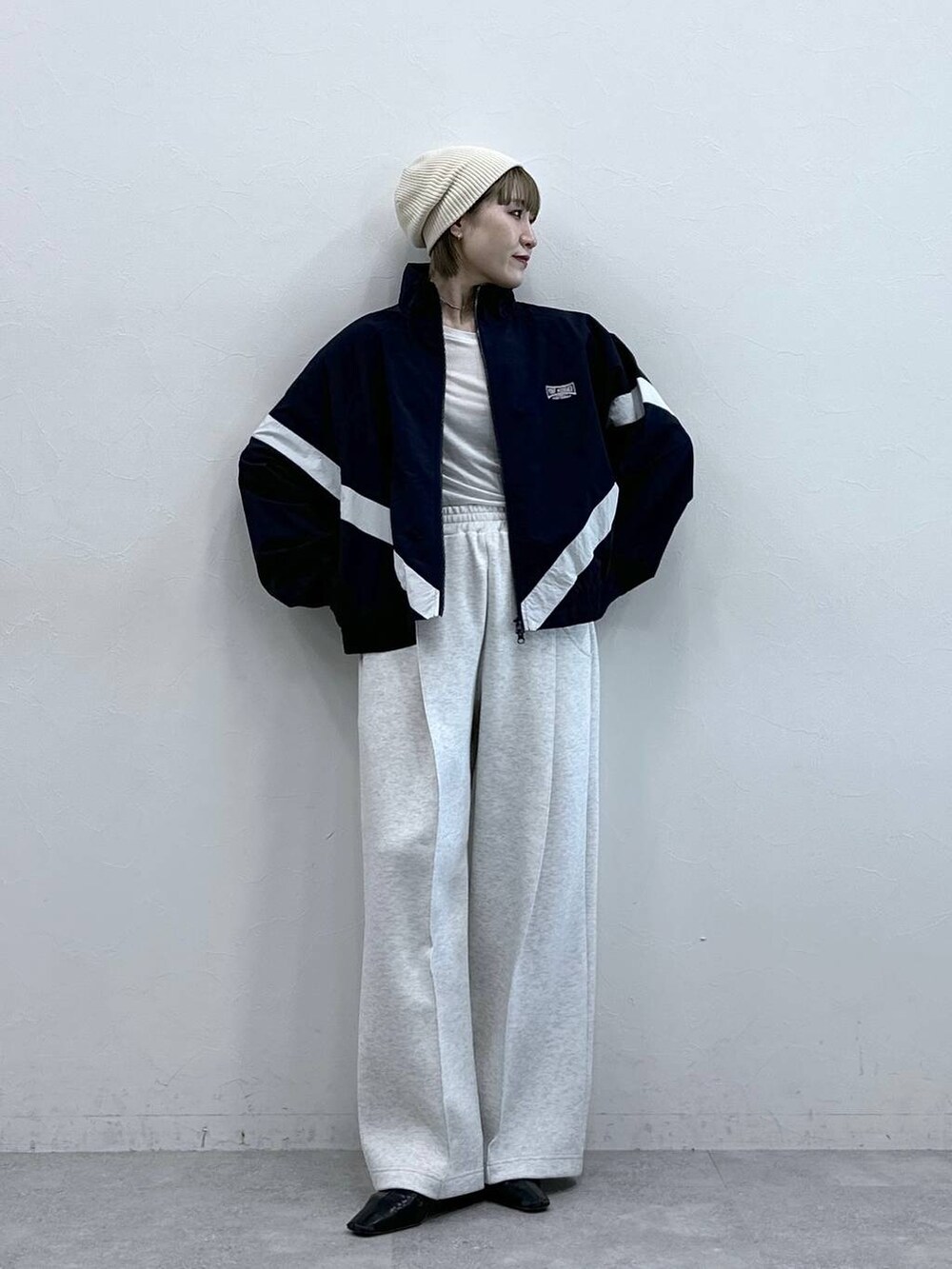 ホワイト系のスウェットパンツ、ブルー系のブルゾン、ホワイト系のTシャツ/カットソーを着用したレディースの冬コーディネートの5枚目の写真