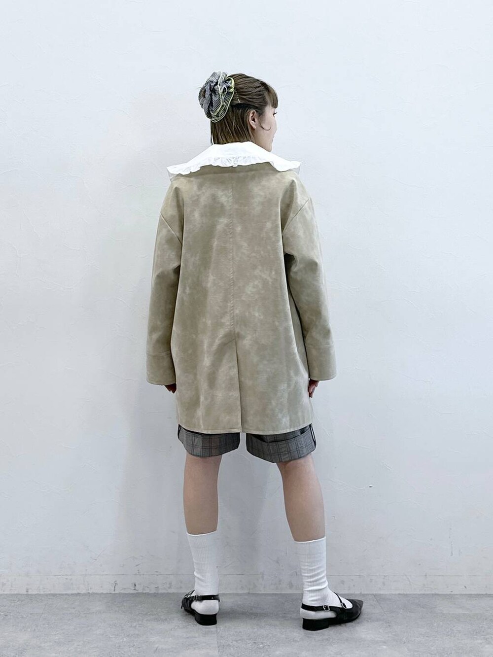 ホワイト系のシャツ/ブラウス、ブラック系のパンプス、ベージュ系のスラックスを着用したレディースの冬コーディネートの5枚目の写真