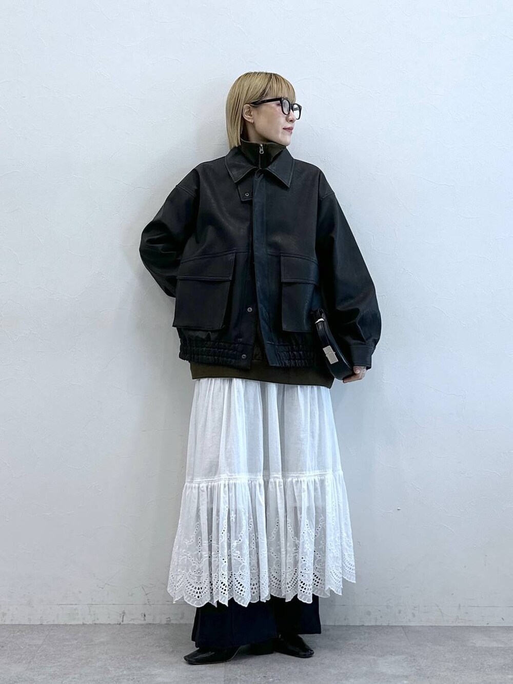 その他のスラックス、ブラック系のブルゾン、ホワイト系のスカートを着用したレディースの夏コーディネートの6枚目の写真
