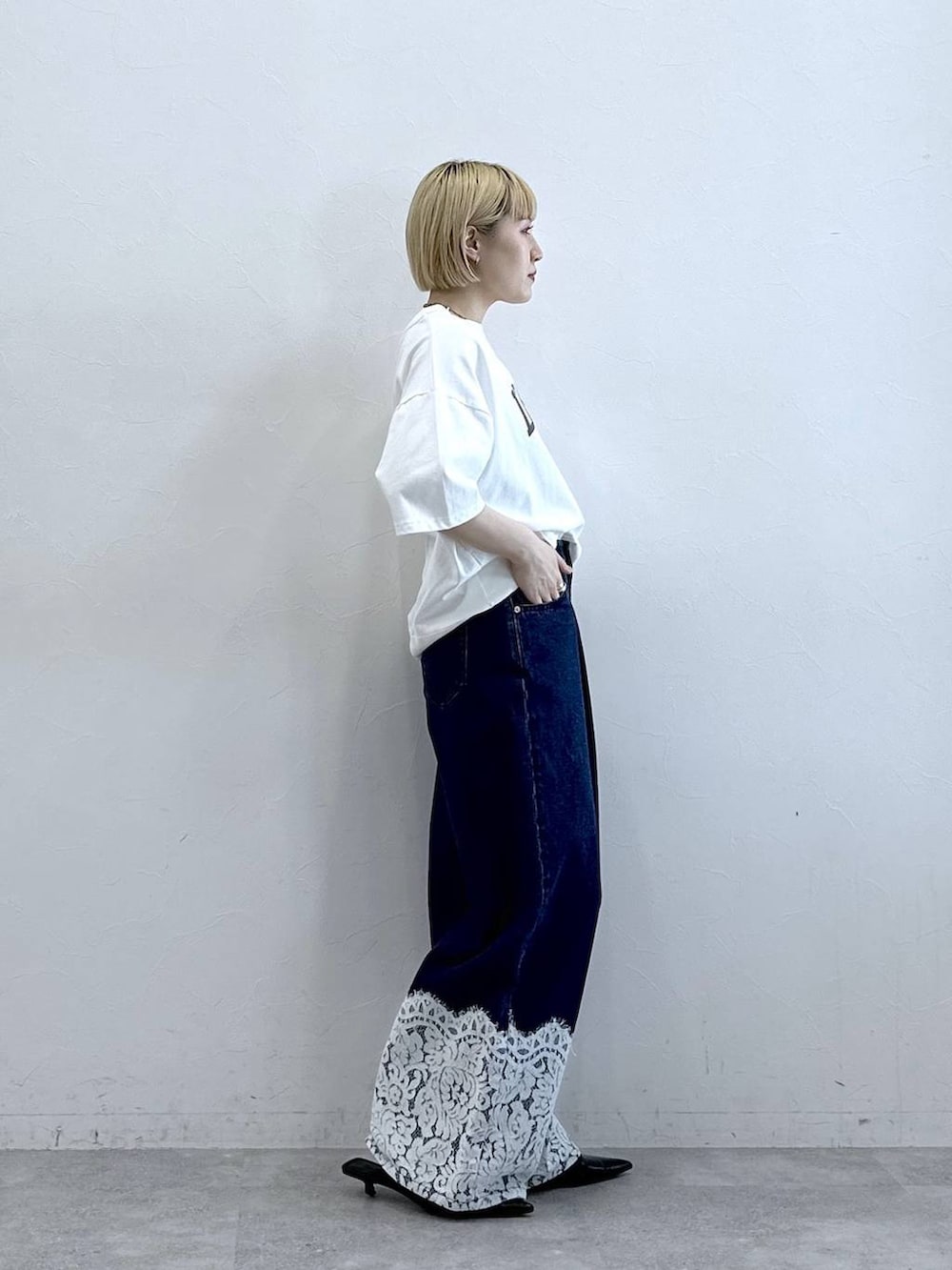 ホワイト系のTシャツ/カットソー、ブルー系のデニムパンツを着用したレディースの春コーディネートの4枚目の写真