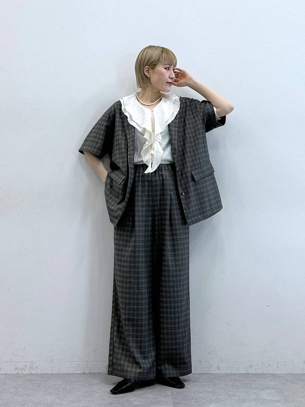 ホワイト系のシャツ/ブラウス、イエロー系のテーラードジャケット、イエロー系のスラックスを着用したレディースの夏コーディネートの2枚目の写真