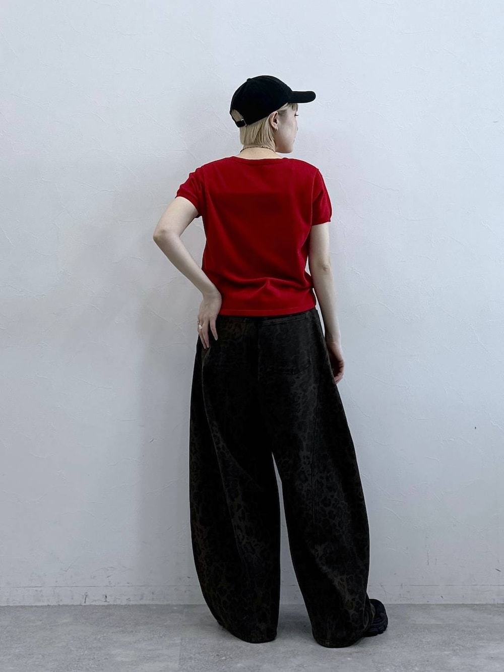 ブラック系のサンダル、ブラウン系のデニムパンツ、レッド系のカーディガン/ボレロを着用したレディースの春コーディネートの5枚目の写真