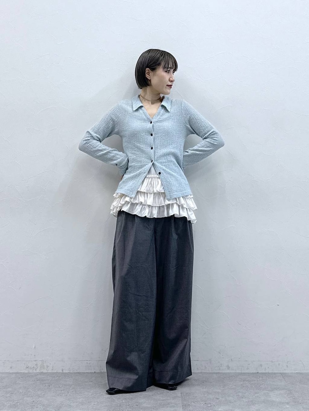 ホワイト系のキャミソール、グレー系のスラックス、ブルー系のカーディガン/ボレロを着用したレディースの春コーディネートの3枚目の写真