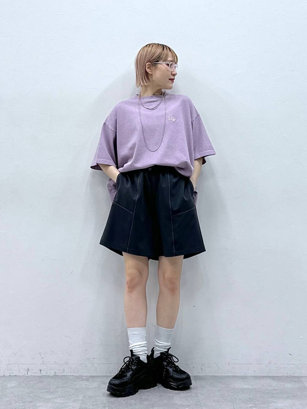 ブラック系のスニーカー、ブルー系のスラックス、ピンク系のTシャツ/カットソーを着用したレディースの春コーディネートの3枚目の写真