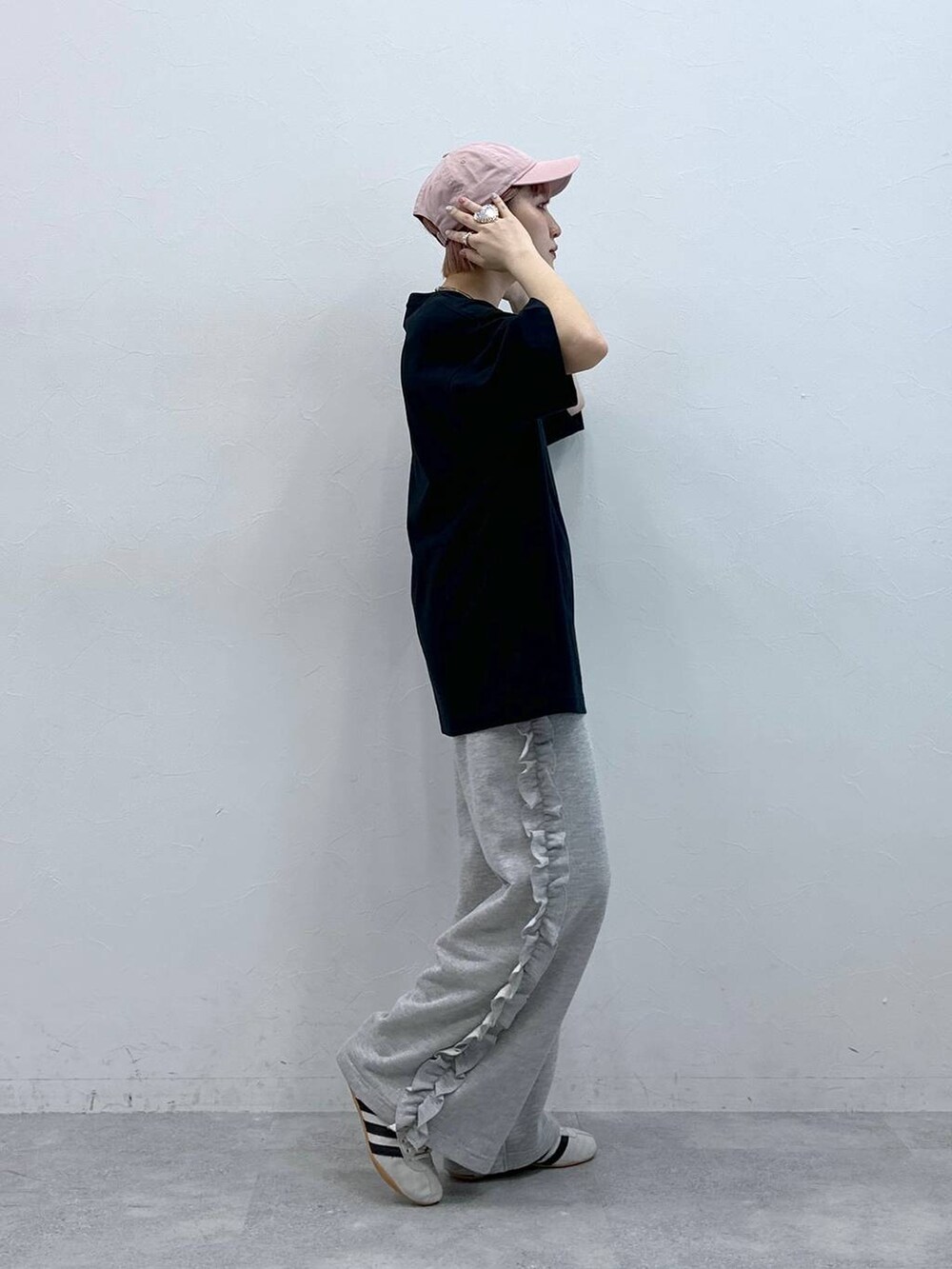 ホワイト系のスニーカー、グレー系のスウェットパンツを着用したレディースの春コーディネートの6枚目の写真