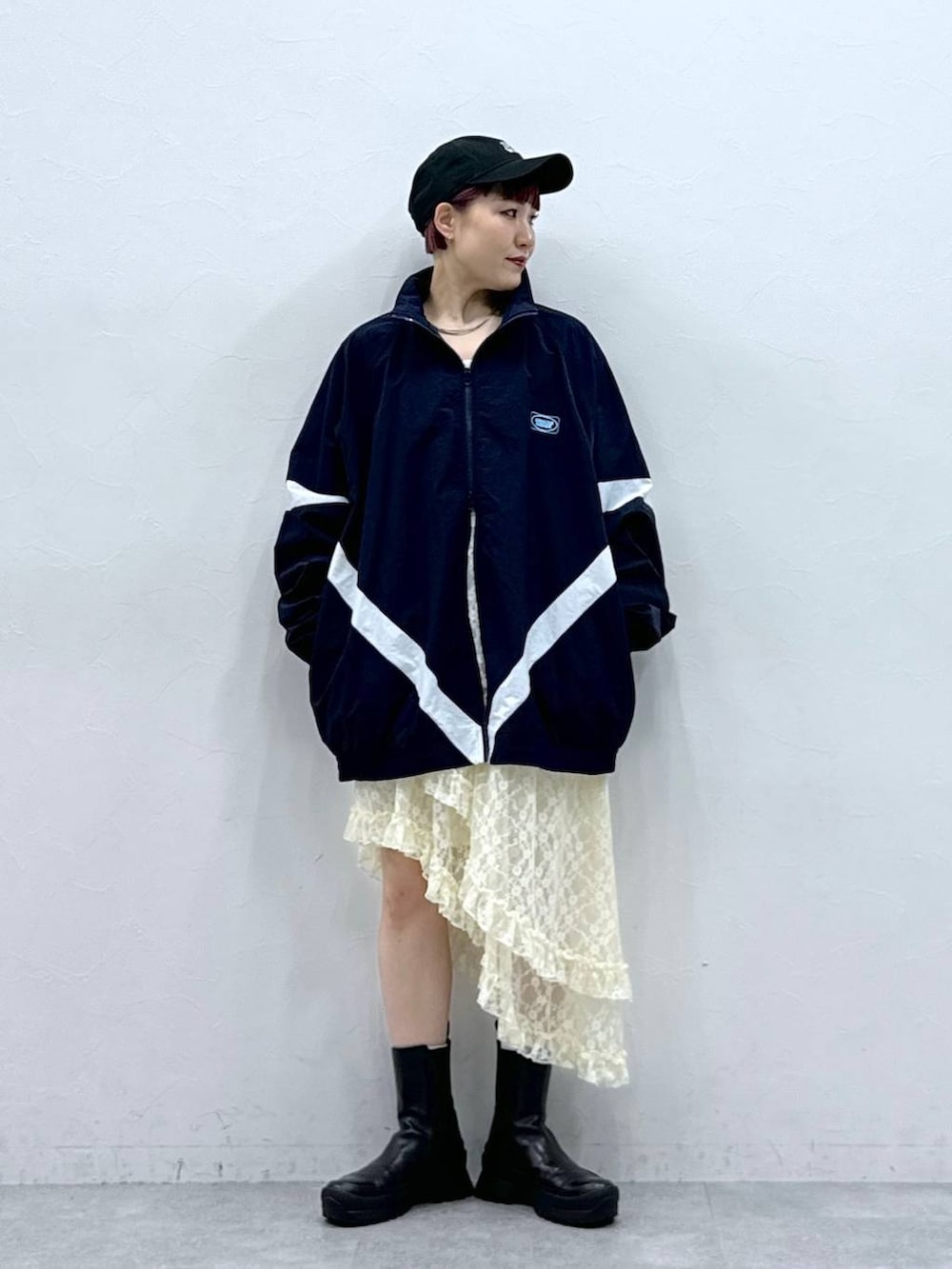 ブルー系のブルゾン、ホワイト系のスカートを着用したレディースの春コーディネートの2枚目の写真