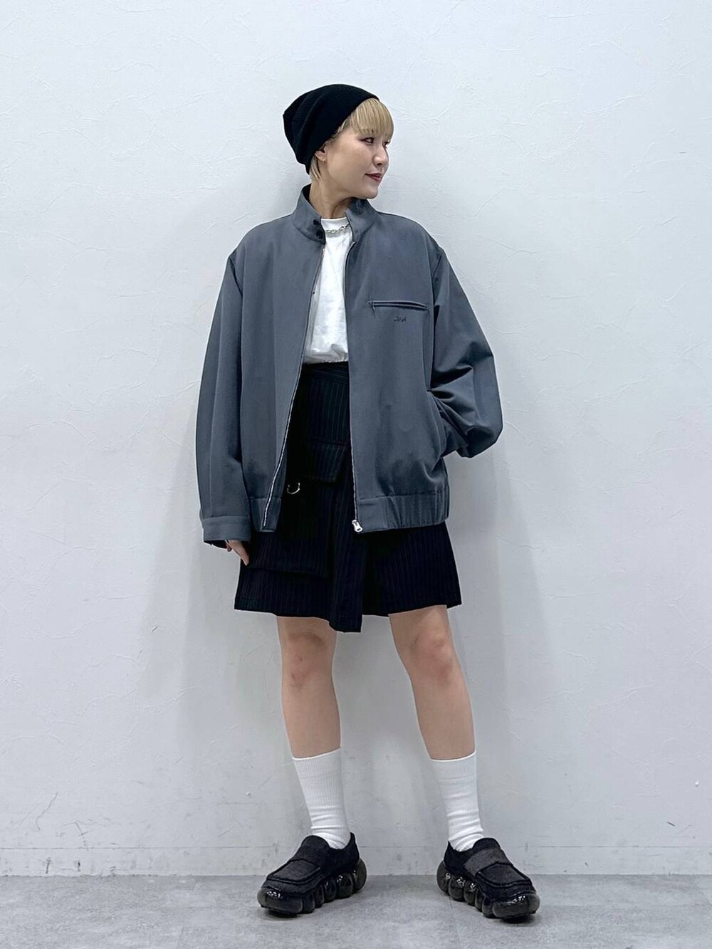 ブラック系のスカート、グレー系のブルゾンを着用したレディースの冬コーディネートの6枚目の写真