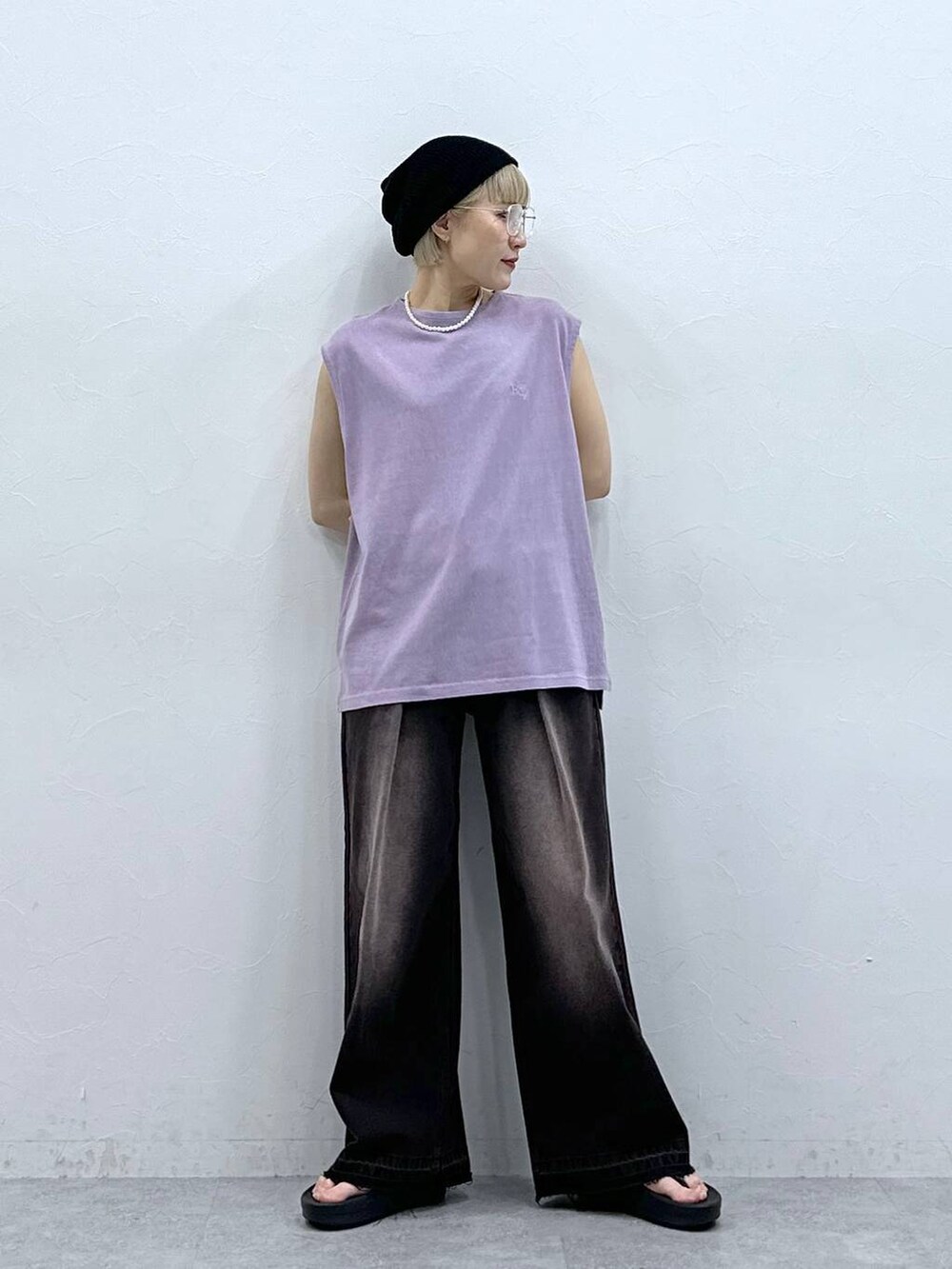 ブラック系のデニムパンツ、パープル系のTシャツ/カットソー、ブラック系のサンダルを着用したレディースの夏コーディネートの5枚目の写真