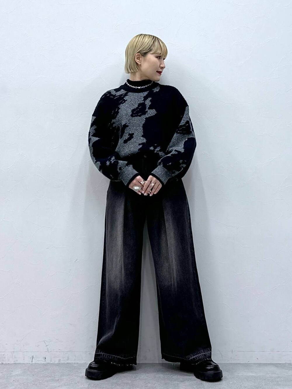 ブラック系のデニムパンツ、ブラック系のニット/セーター、ブラック系のローファーを着用したレディースの冬コーディネートの2枚目の写真