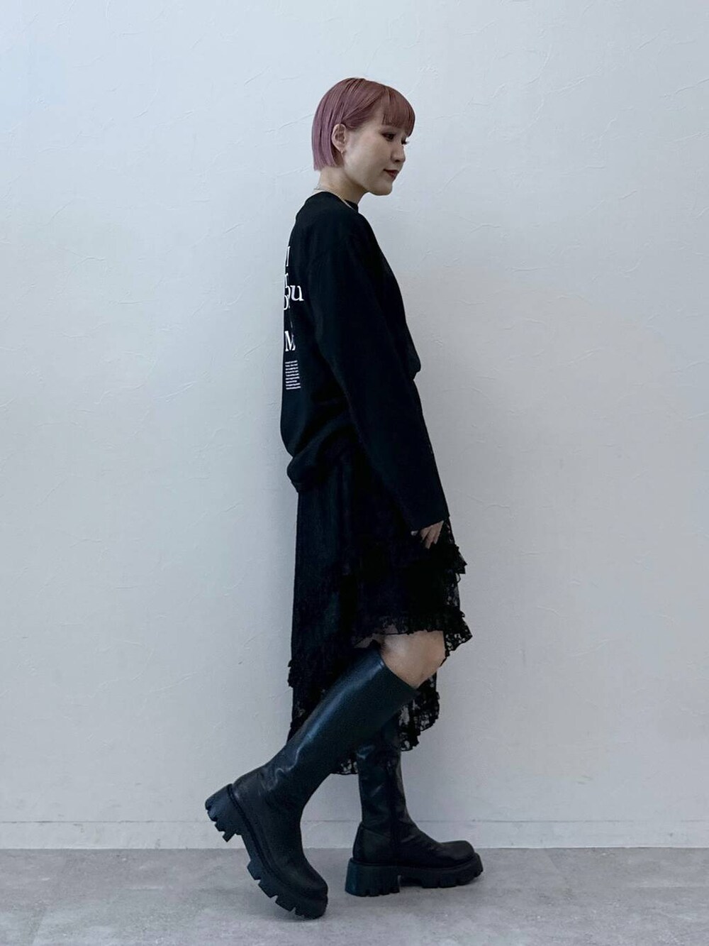 ブラック系のブーツ、ブラック系のTシャツ/カットソー、ブラック系のスカートを着用したレディースの冬コーディネートの4枚目の写真