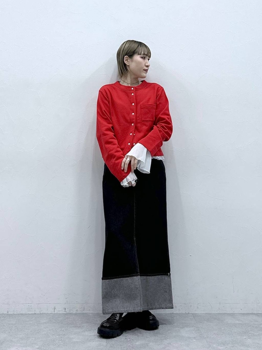 ブラック系のローファー、レッド系のカーディガン/ボレロ、ホワイト系のTシャツ/カットソーを着用したレディースの冬コーディネートの3枚目の写真