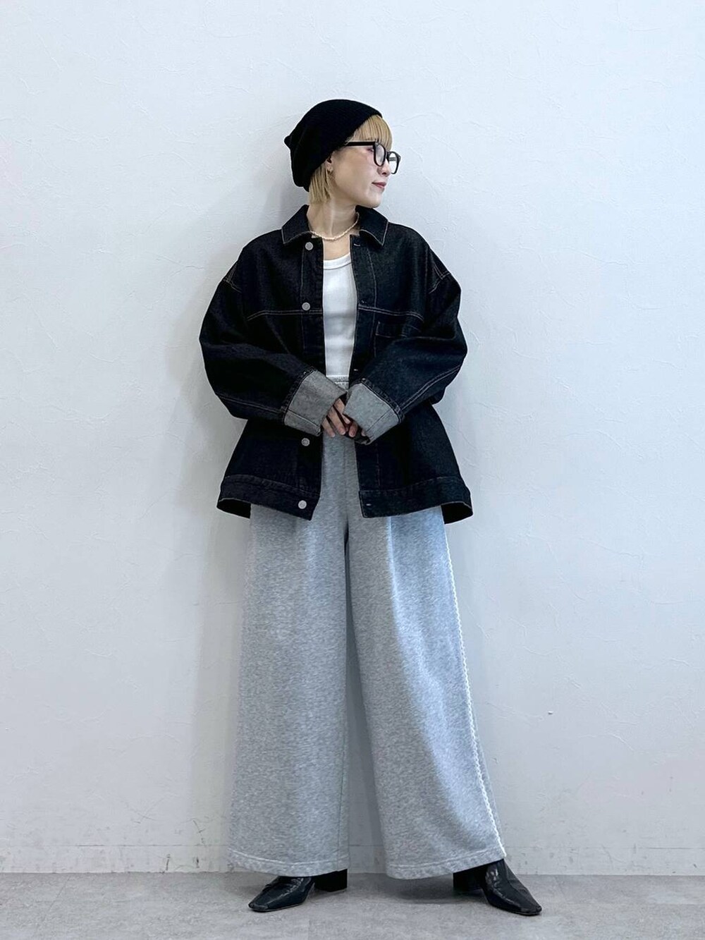 ブラック系のデニムジャケット、グレー系のスウェットパンツ、ブラック系のニットキャップ/ビーニーを着用したレディースの夏コーディネートの2枚目の写真